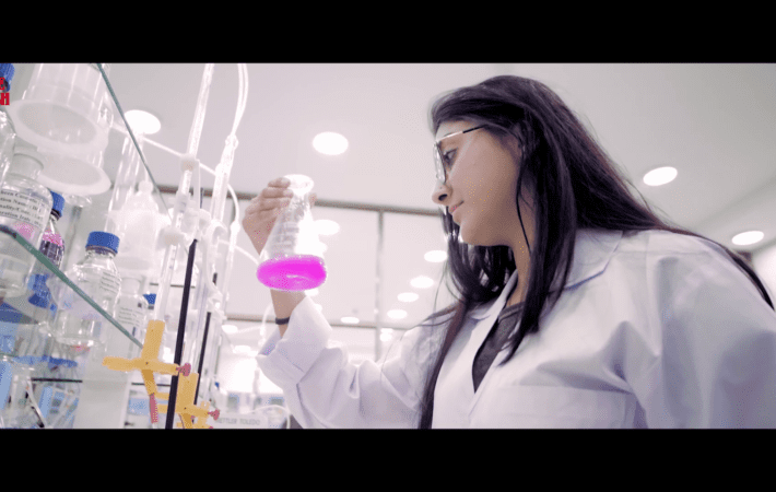 Lab grown ingredients process for biotech skincare shown in a clean scientific laboratory with glass bioreactors.