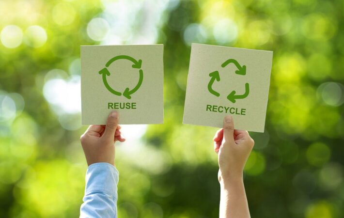 Comparison of refillable glass jar with paper pouch refill and recyclable aluminum tube and glass bottle on wooden surface
