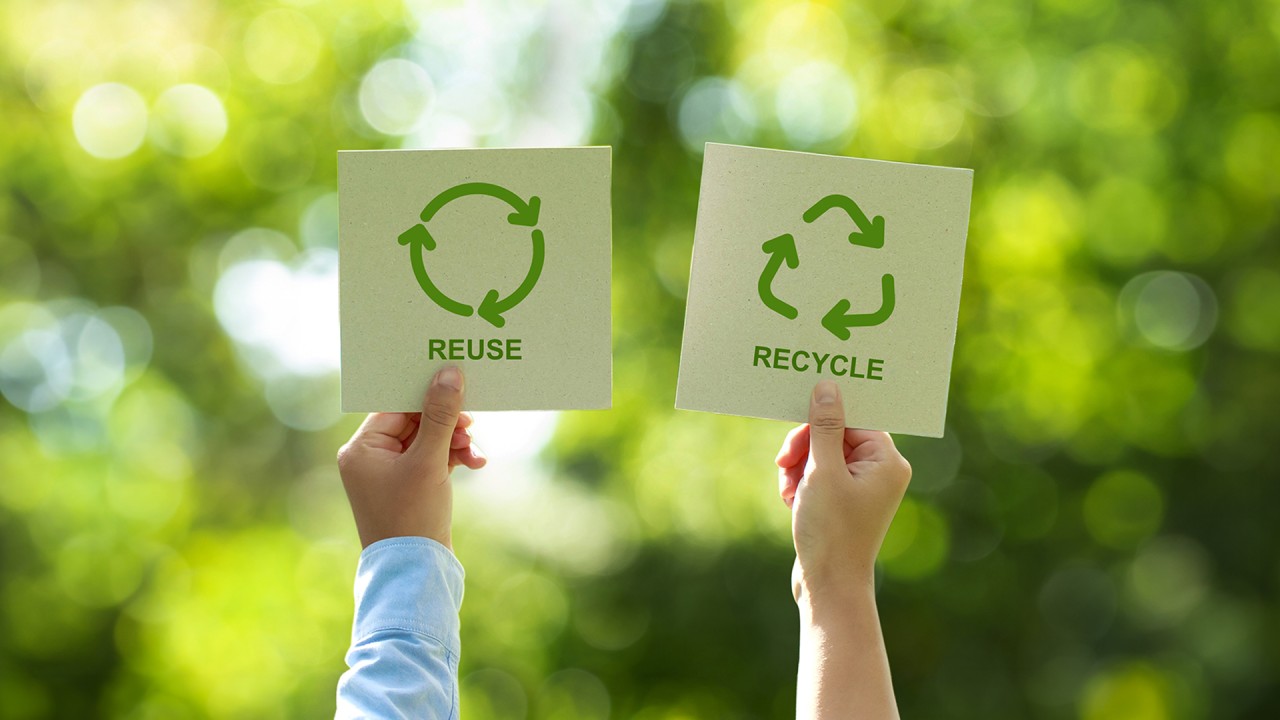 Comparison of refillable glass jar with paper pouch refill and recyclable aluminum tube and glass bottle on wooden surface